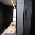 Black tiled bathroom shower area
