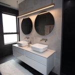 Grey tiled bathroom with two sinks