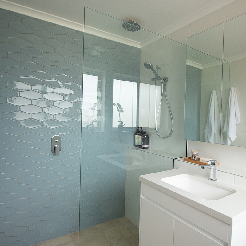 Renovated bathroom with blue hexagon tiles