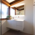 White tiled bathroom with floating sink counter