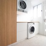 White laundry with wooden counter and laundry