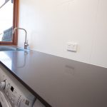 Laundry with stone countertop